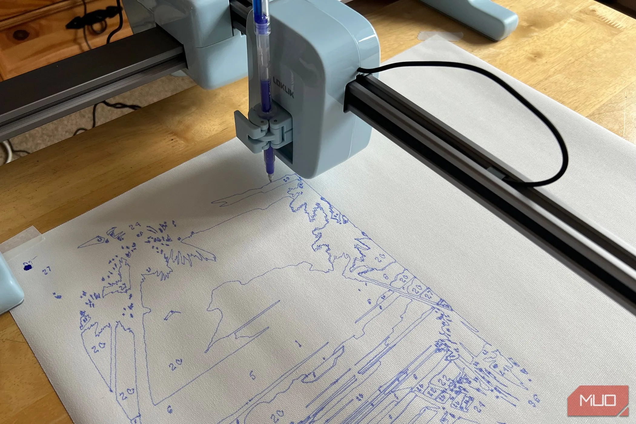Bút vẽ nhiệt LOKLiK đang vẽ đường nét trên tấm canvas trắng