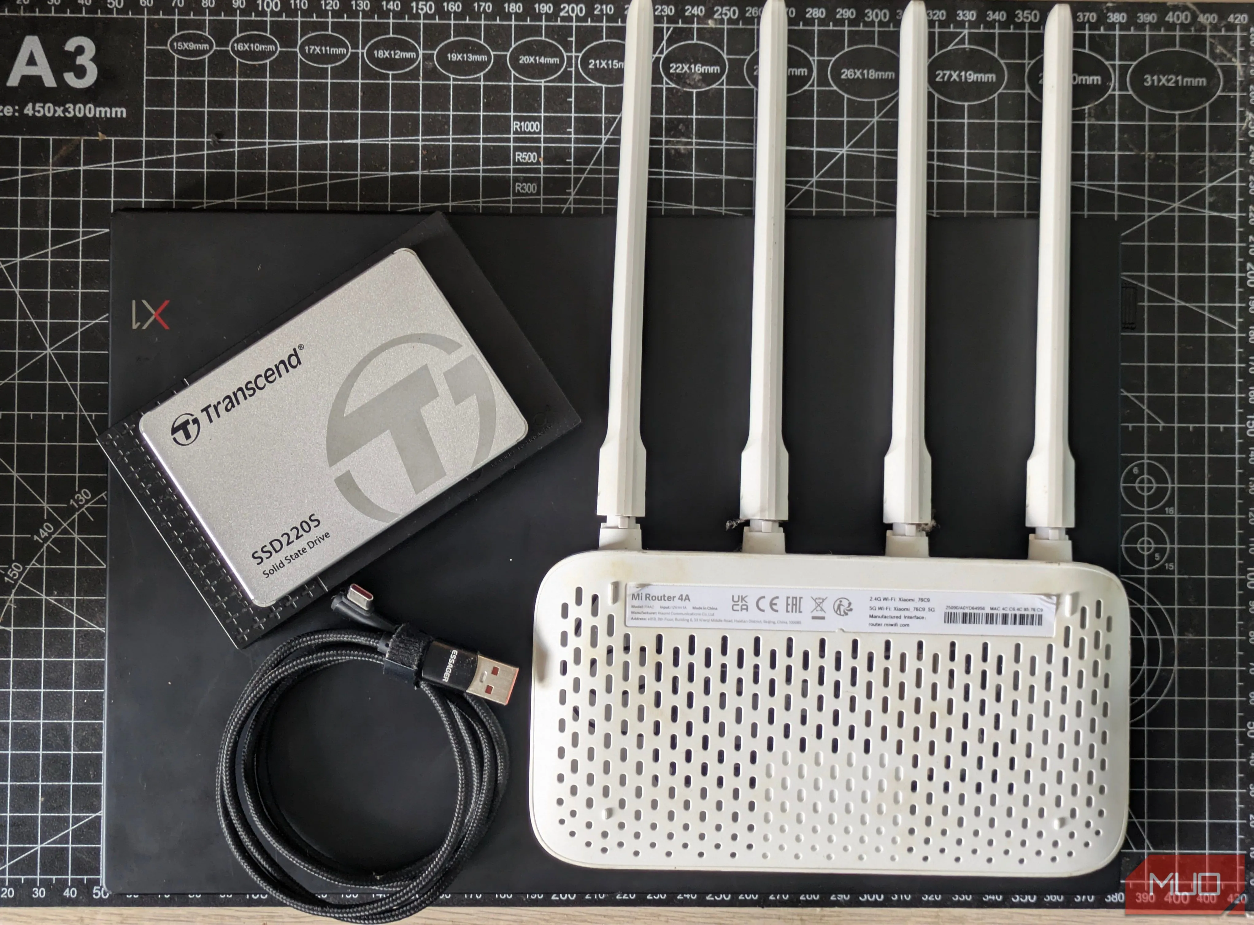 Các bộ phận cần thiết để xây dựng NAS bằng router, bao gồm router, ổ cứng SSD ngoài và cáp USB