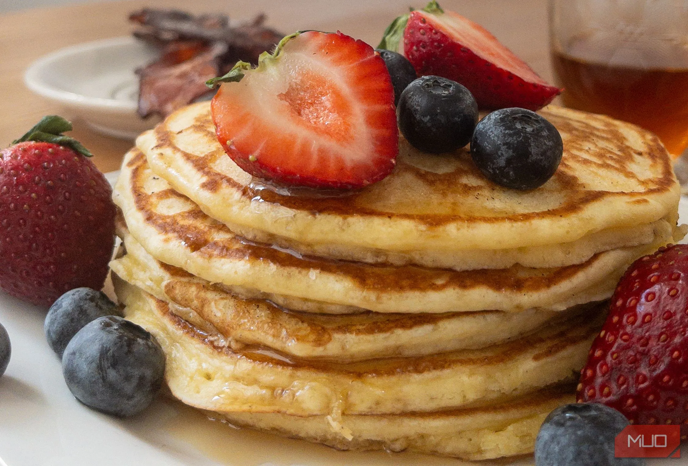 Chồng bánh pancake hấp dẫn với sốt và trái cây, chụp từ góc trên cao