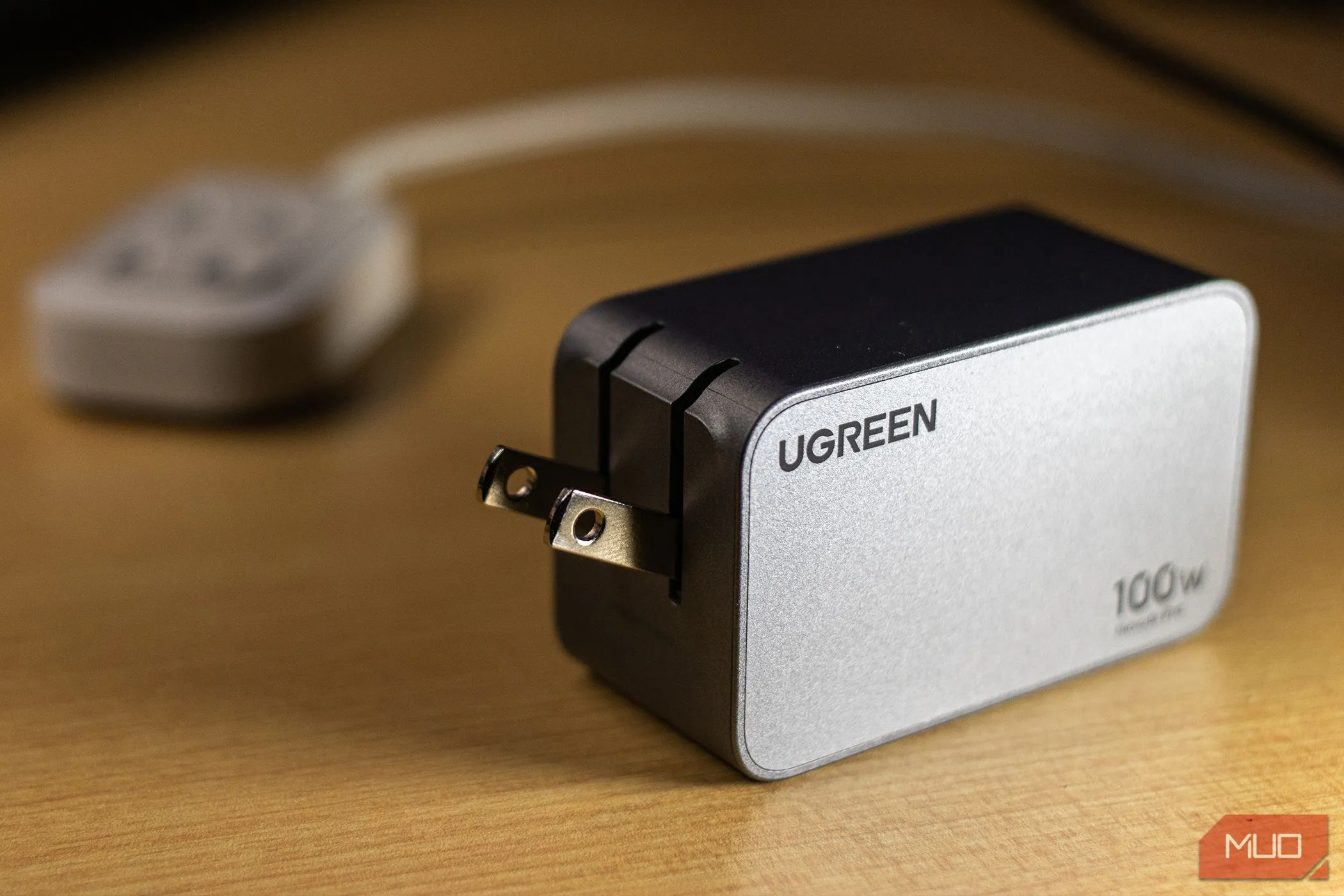 Củ sạc tường USB-C Ugreen Nexode Pro 100W màu trắng với thiết kế gập gọn, tượng trưng cho tốc độ và khả năng sạc đa thiết bị.