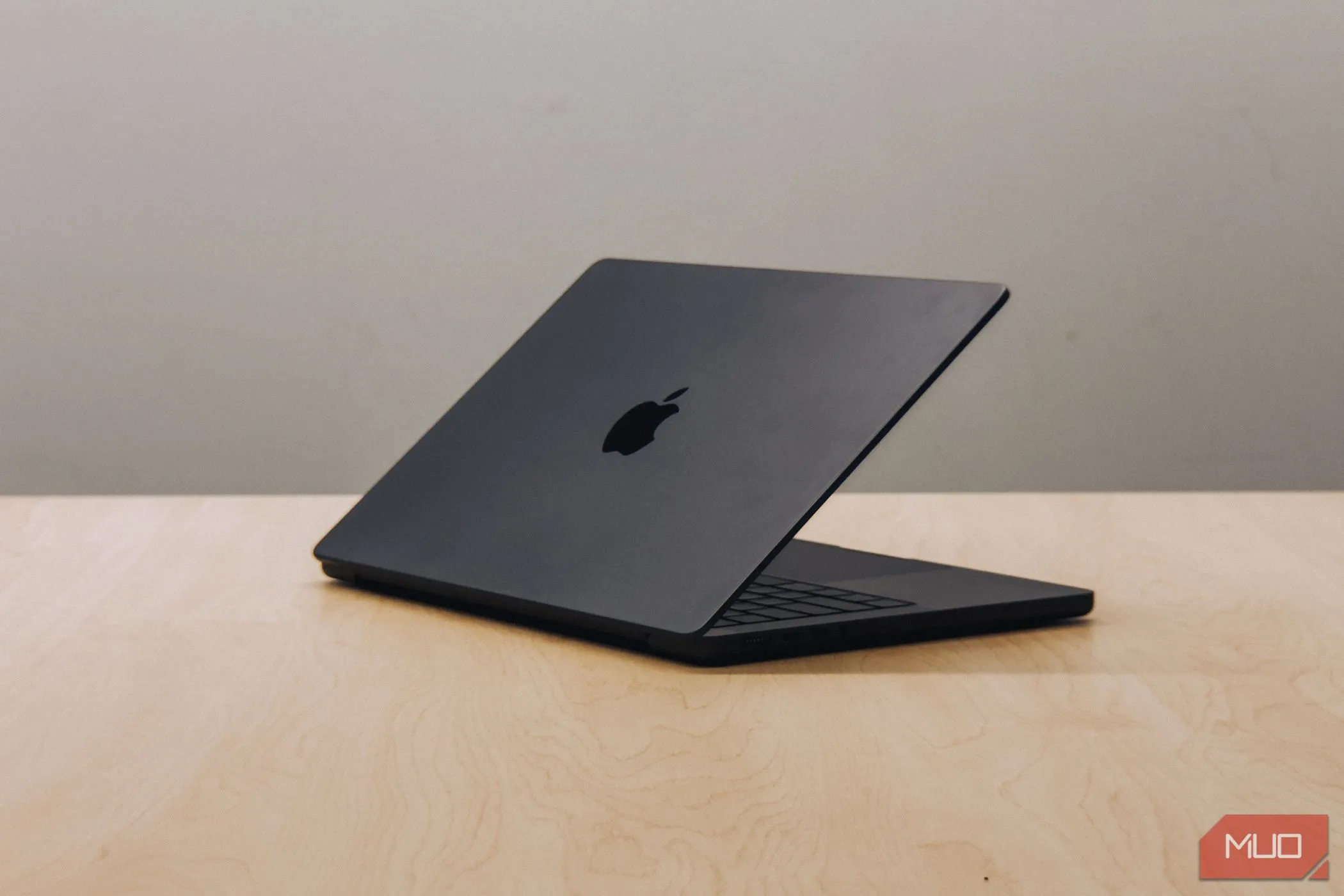 MacBook Pro chạy chip M4 với màn hình úp xuống trên bàn gỗ, biểu tượng cho sự chuyển đổi của Apple sang nền tảng Apple Silicon
