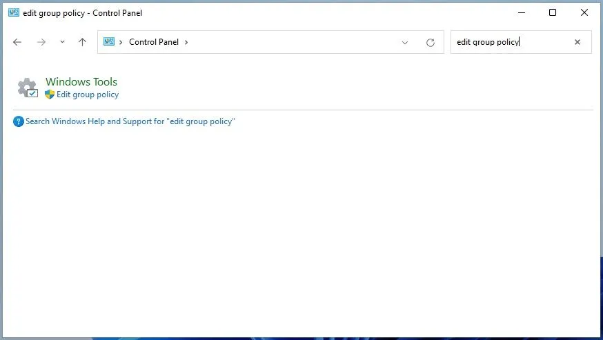 Mở Local Group Policy Editor từ cửa sổ Control Panel hoặc ứng dụng Settings bằng cách tìm kiếm 'edit group policy'