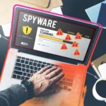 Người dùng laptop thực hiện quét phần mềm gián điệp, xuất hiện các cảnh báo bảo mật