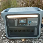 Trạm năng lượng di động Anker Solix C1000 màu đen đặt trên thảm cỏ xanh, thể hiện khả năng sử dụng linh hoạt ngoài trời cho các thiết bị điện tử.