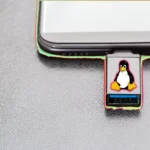 USB cứu hộ SystemRescue với logo chim cánh cụt Linux cắm vào máy tính xách tay